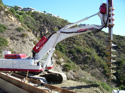 Excavator-mounted drilling rig